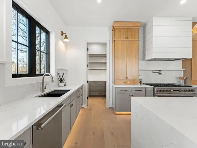 a bathroom with a double vanity sink a mirror and a shower