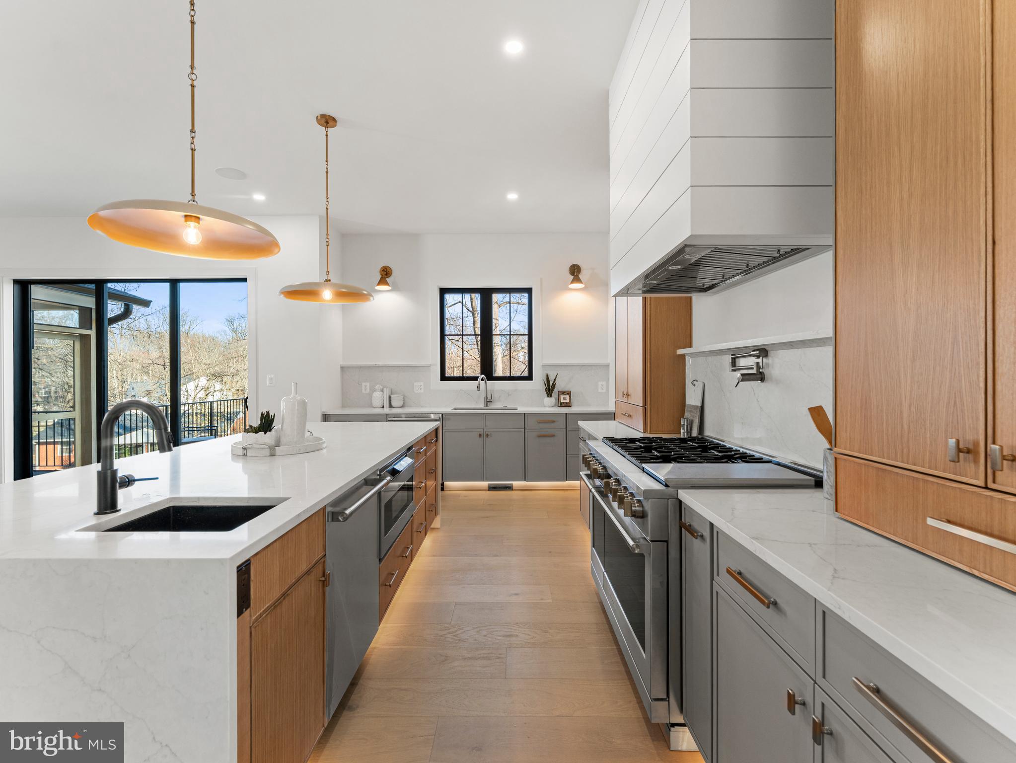 406 Dove Circle Southwest Vienna, VA 22180 - Photo 18 of 47 a kitchen with stainless steel appliances granite countertop a sink a stove and a wooden floors