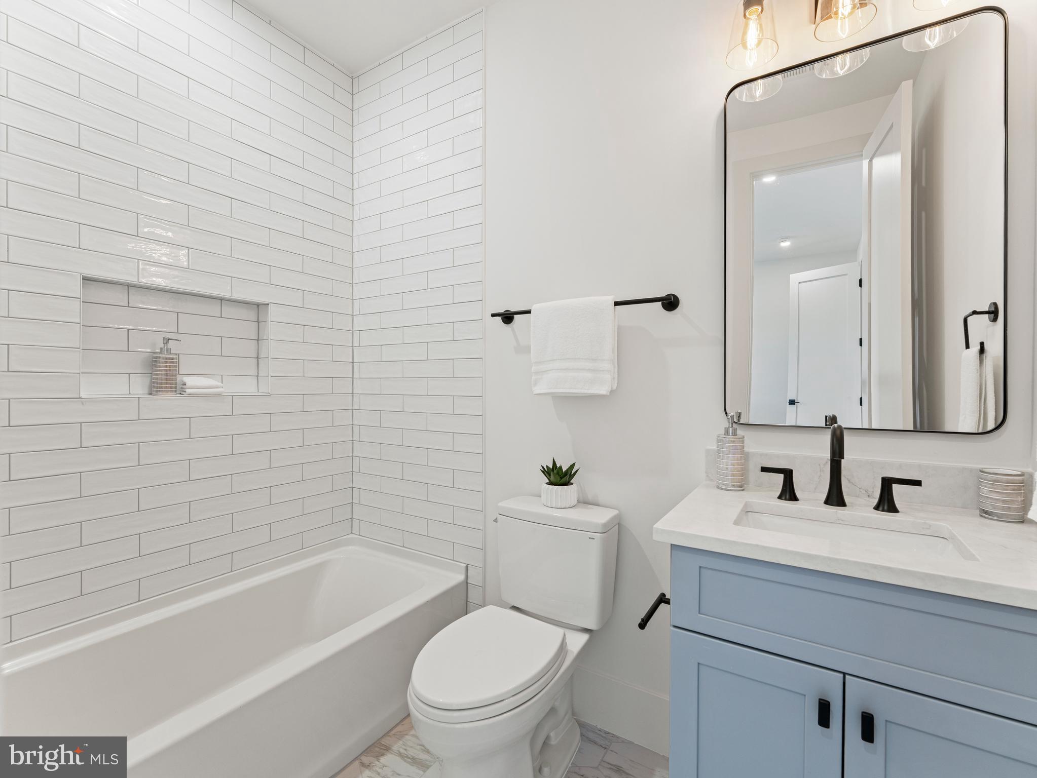 406 Dove Circle Southwest Vienna, VA 22180 - Photo 35 of 47 a bathroom with a toilet a sink and bathtub
