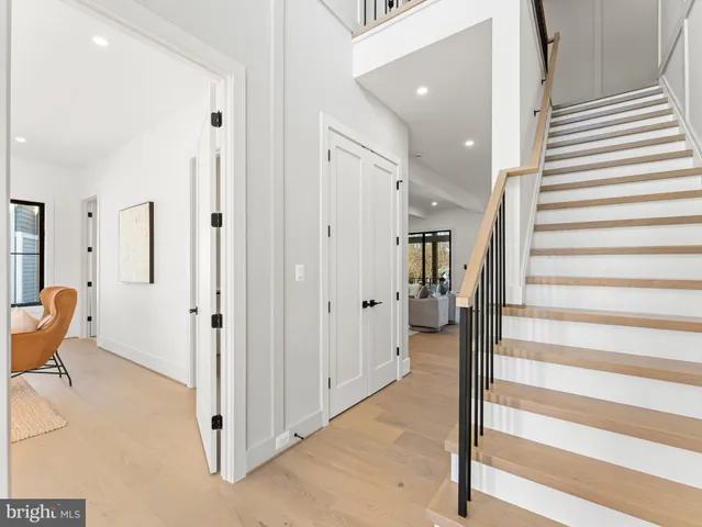 a kitchen with stainless steel appliances granite countertop a sink a stove and a wooden floors