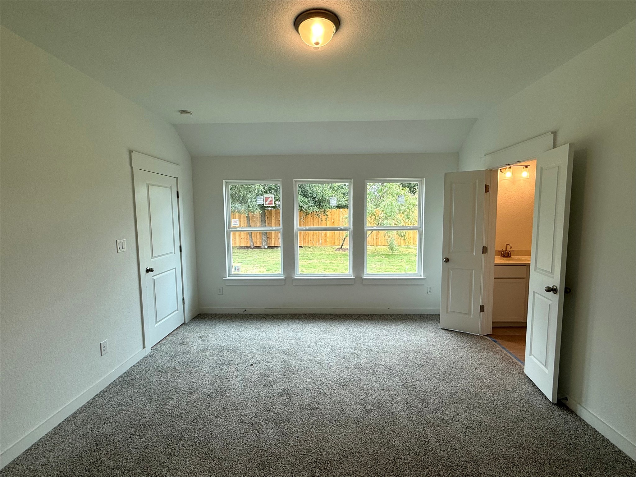 13615 Barn Chime Street Elgin, TX 78621 - Photo 6 of 8 a view of an empty room with a window and a kitchen