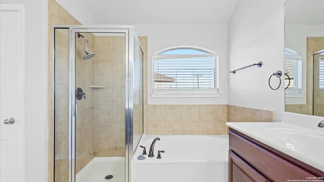 a bathroom with a bathtub and a shower