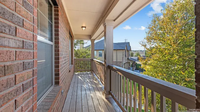 a view of a balcony with wooden floor and stairs