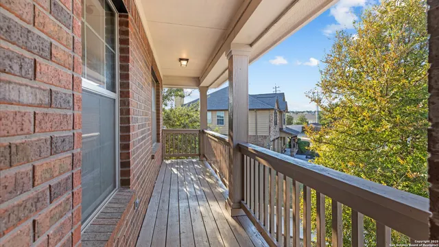 a view of a balcony with wooden floor and stairs