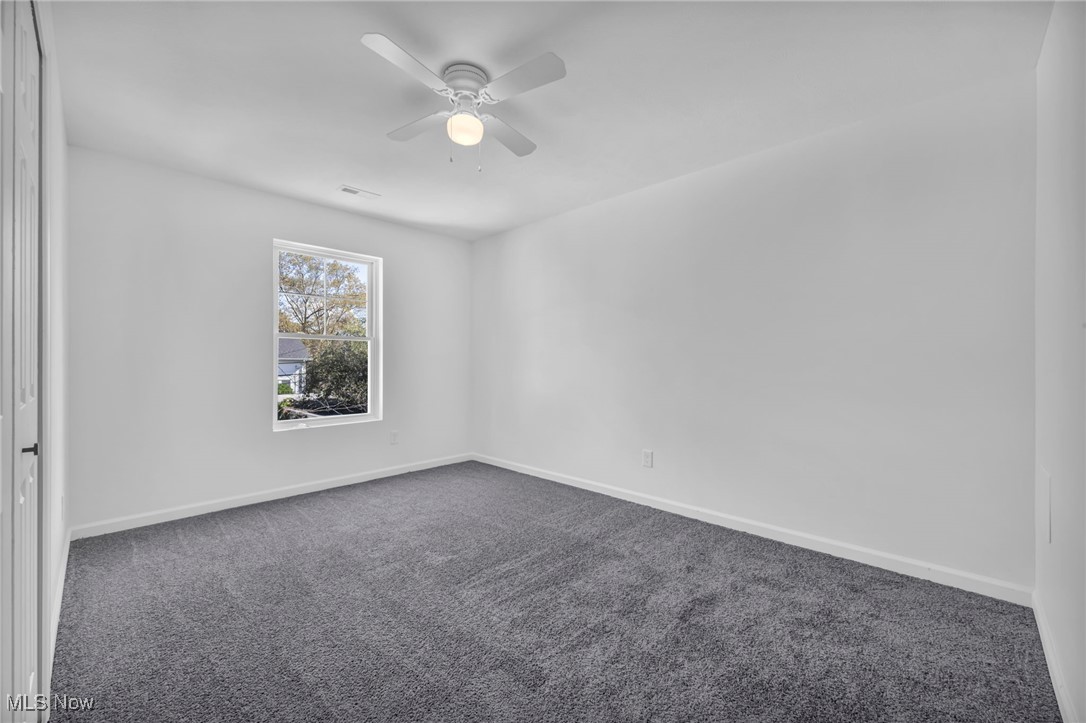 3653 Pennington Road Cleveland, OH 44120 - Photo 29 of 41 Unfurnished room featuring dark colored carpet and ceiling fan