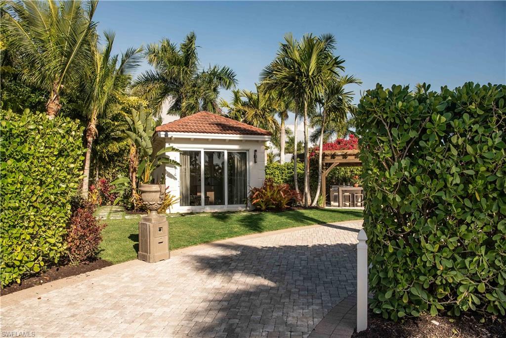 13614 Snapper Lane Naples, FL 34114 - Photo 19 of 19 a front view of a house with a yard and shrubs