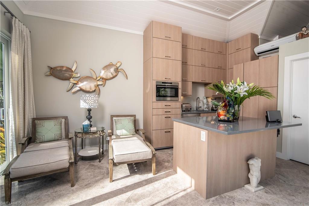 13614 Snapper Lane Naples, FL 34114 - Photo 2 of 19 a view of kitchen with furniture and wooden floor