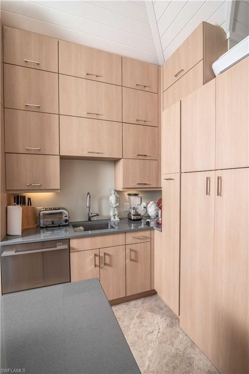 13614 Snapper Lane Naples, FL 34114 - Photo 4 of 19 a kitchen with stainless steel appliances a sink a stove a refrigerator and cabinets