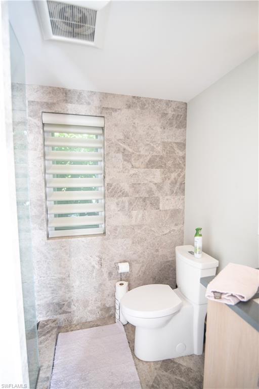 13614 Snapper Lane Naples, FL 34114 - Photo 8 of 19 a bathroom with a granite countertop toilet and a sink