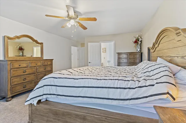 a bedroom with a bed and a dresser with mirror