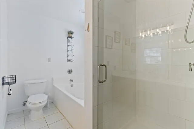 a bathroom with a toilet shower and a shower