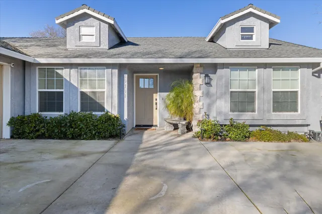 a front view of a house with garden
