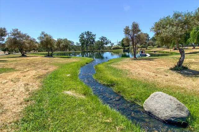 a view of a lake with houses in the back