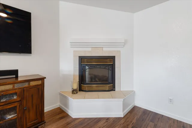 a living room with a fireplace and a flat screen tv
