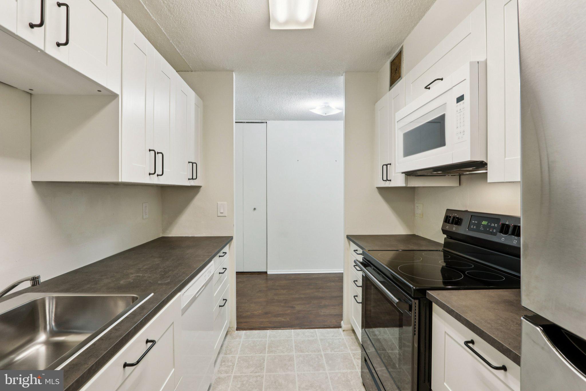 1420 Locust Street, Unit 7O Philadelphia, PA 19102 - Photo 12 of 53 a kitchen with stainless steel appliances granite countertop a sink and a stove