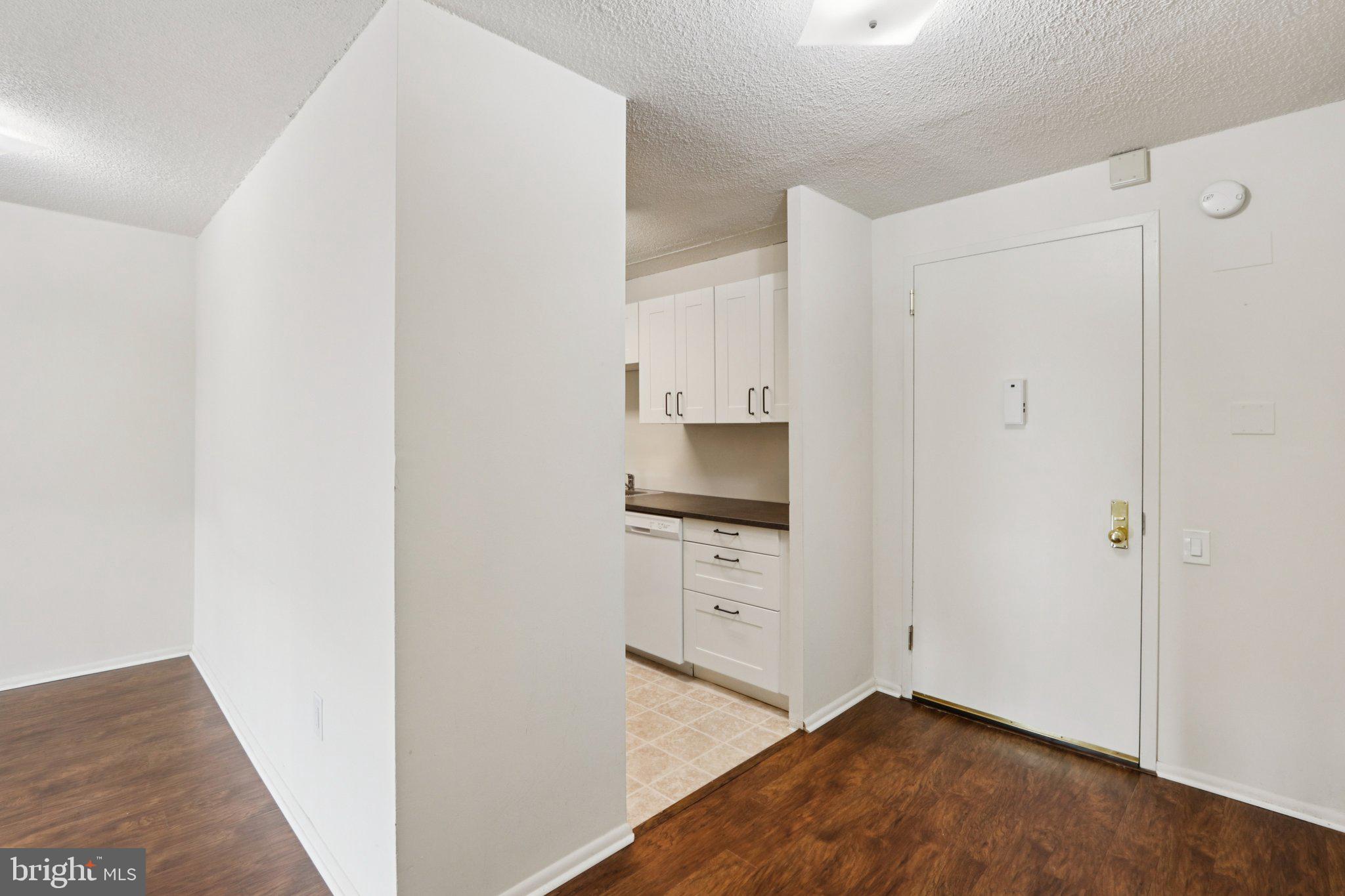 1420 Locust Street, Unit 7O Philadelphia, PA 19102 - Photo 14 of 53 a kitchen with white cabinets and white appliances