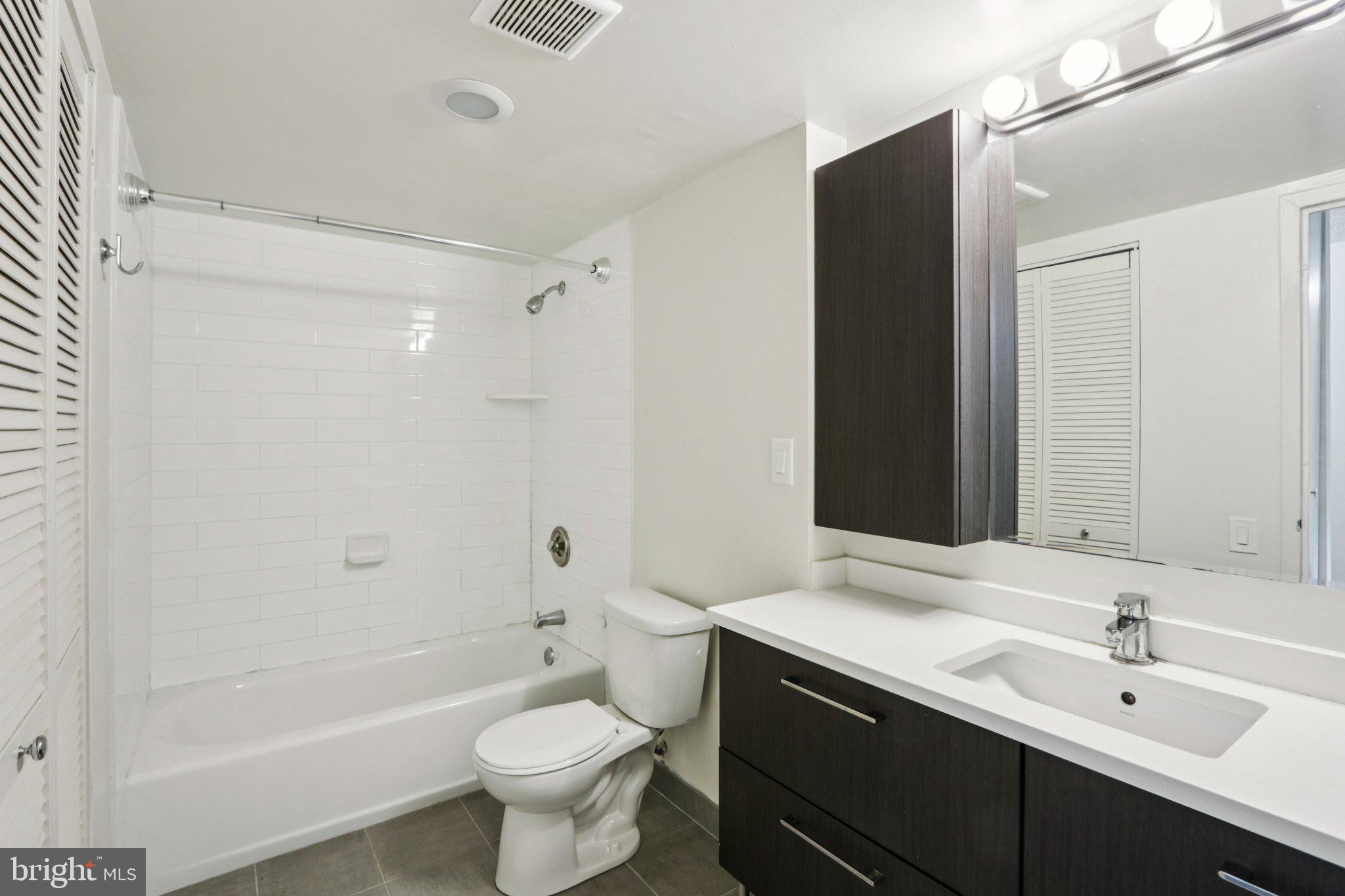 1420 Locust Street, Unit 7O Philadelphia, PA 19102 - Photo 15 of 53 a bathroom with a double vanity sink toilet and shower