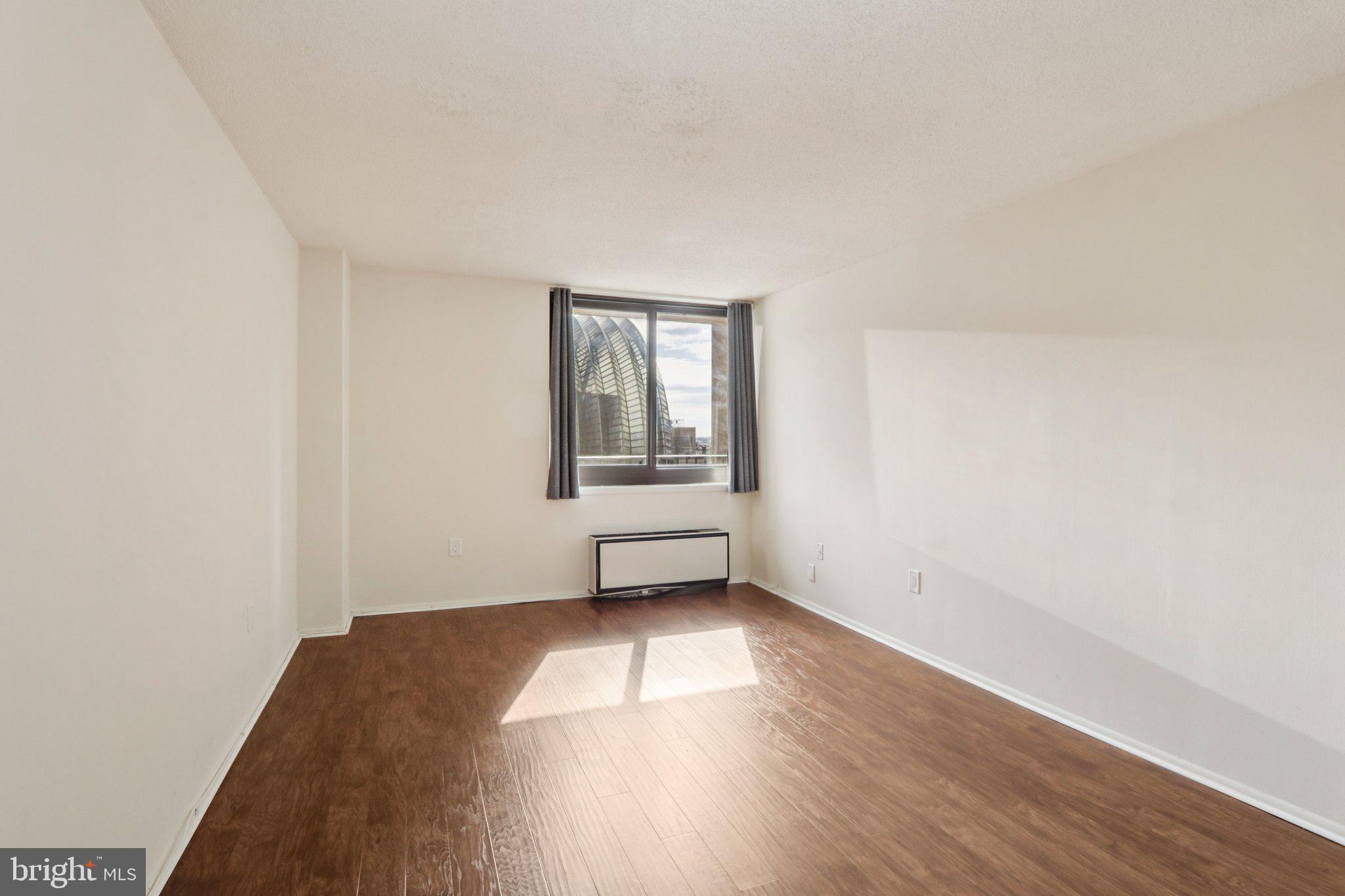 1420 Locust Street, Unit 7O Philadelphia, PA 19102 - Photo 23 of 53 an empty room with wooden floor and windows
