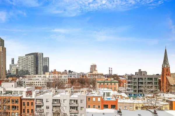 a bedroom with furniture and a large window