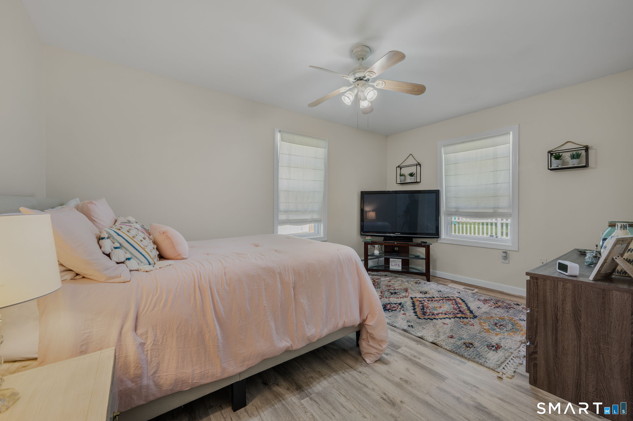 212 R Shore Road Waterford, CT 06385 - Photo 20 of 28 a bedroom with a bed and wooden floor