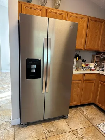 a utility room with cabinets washer and dryer