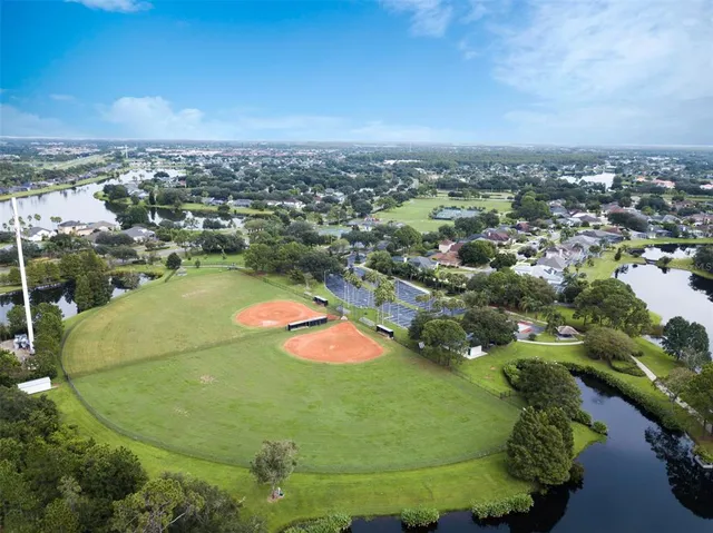 an aerial view of a house with outdoor space pool seating area and yard