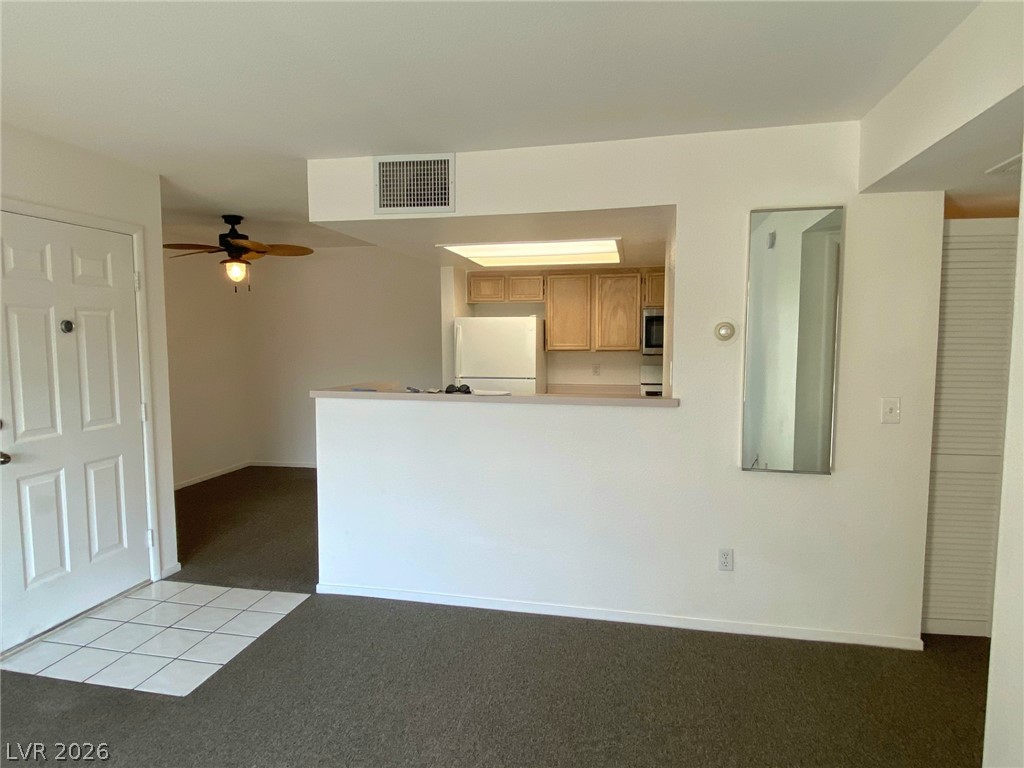 8070 West Russell Road, Unit 2105 Las Vegas, NV 89113 - Photo 2 of 10 An open concept living area connects seamlessly to a well-equipped kitchen and dining area.