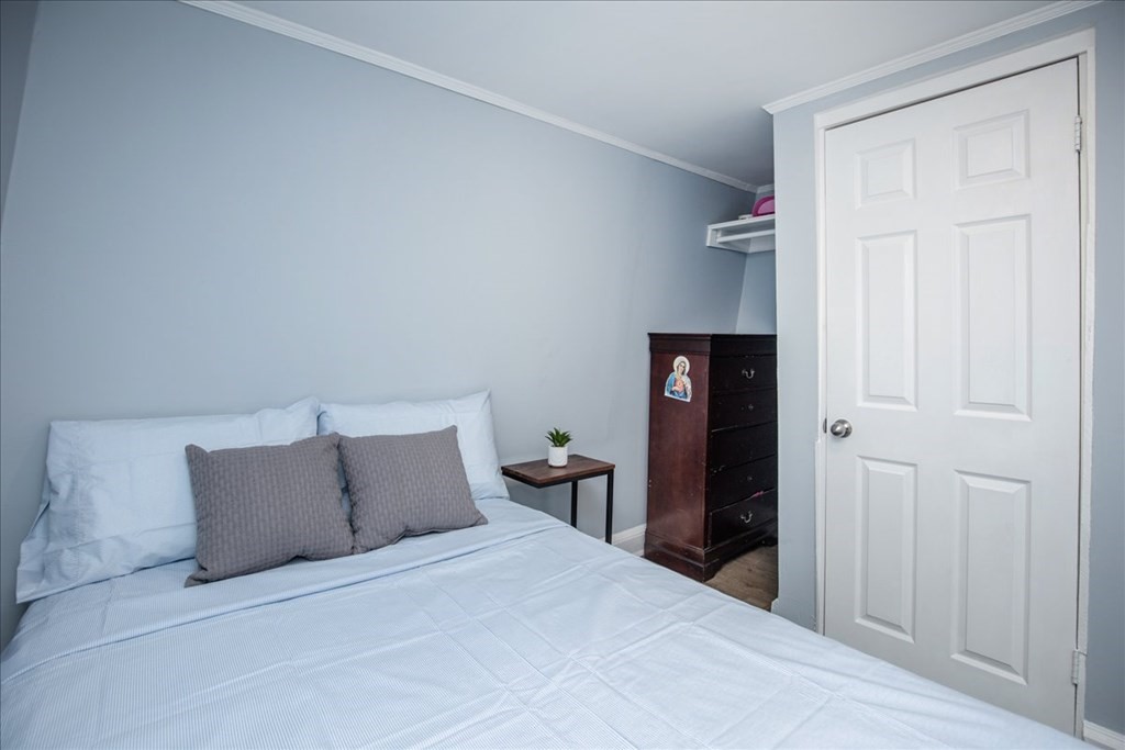 30 Eleanor Street Chelsea, MA 02150 - Photo 14 of 23 a bedroom with a bed and closet