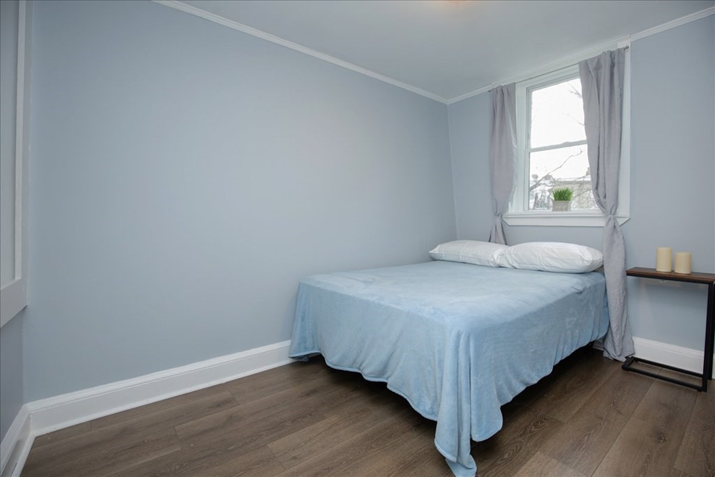 30 Eleanor Street Chelsea, MA 02150 - Photo 16 of 23 a bedroom with a bed and window