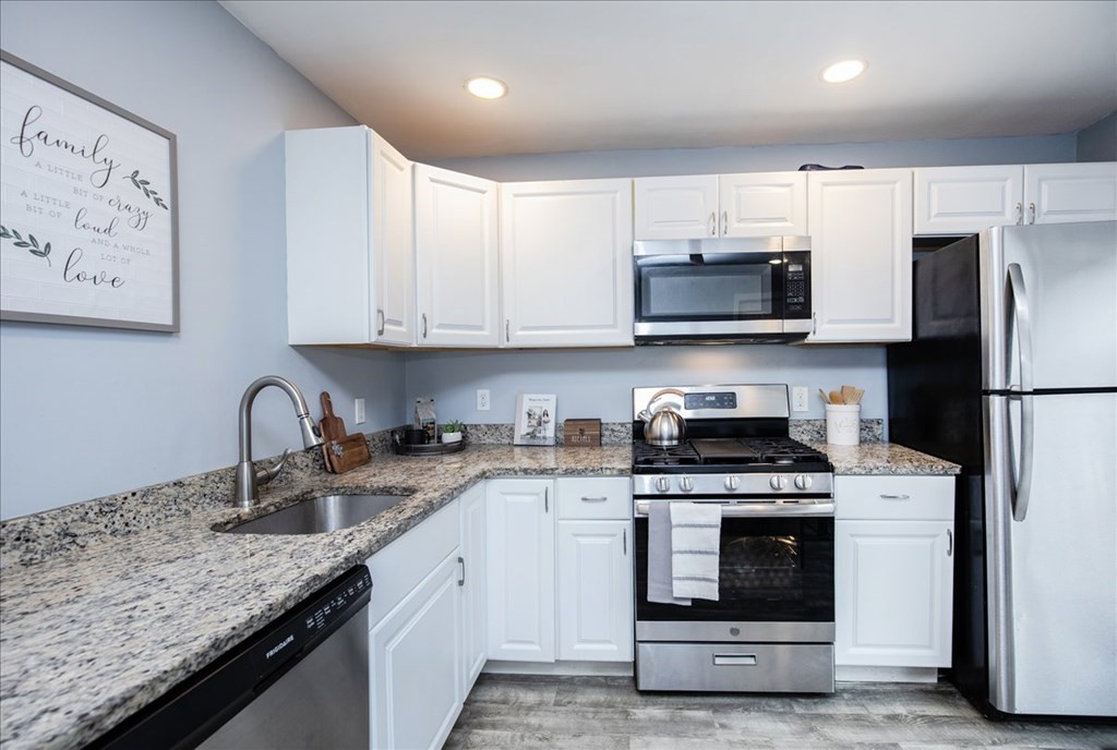 30 Eleanor Street Chelsea, MA 02150 - Photo 8 of 23 a kitchen with granite countertop a sink stainless steel appliances and cabinets