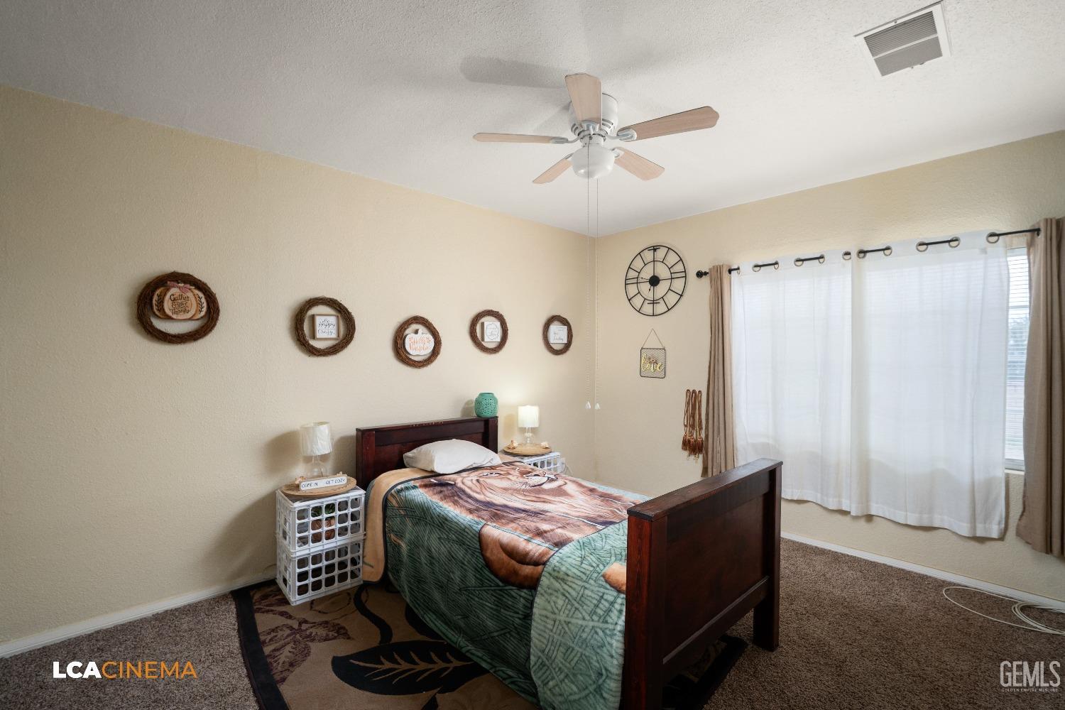 Undisclosed Address Bakersfield, CA 93307 - Photo 11 of 18 a bedroom with a bed and a chandelier
