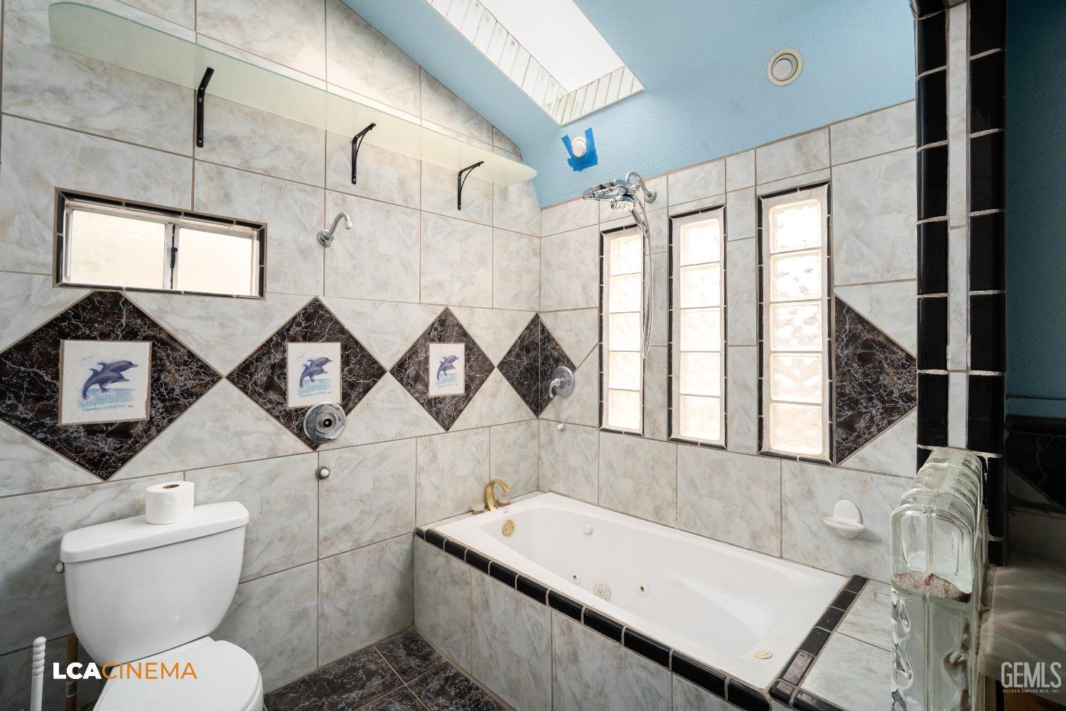 Undisclosed Address Bakersfield, CA 93307 - Photo 13 of 18 a bathroom with a toilet sink and mirror