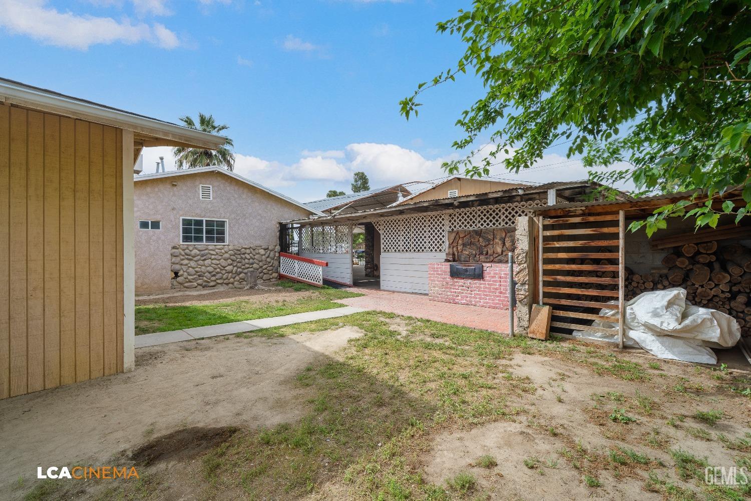 Undisclosed Address Bakersfield, CA 93307 - Photo 14 of 18 a front view of a house with a yard and garage