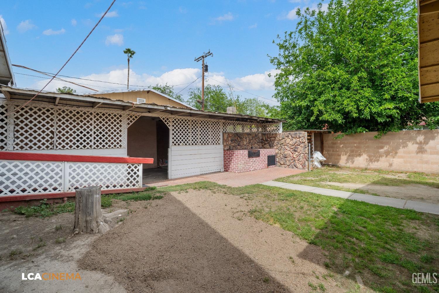 Undisclosed Address Bakersfield, CA 93307 - Photo 16 of 18 a front view of a house with a garden