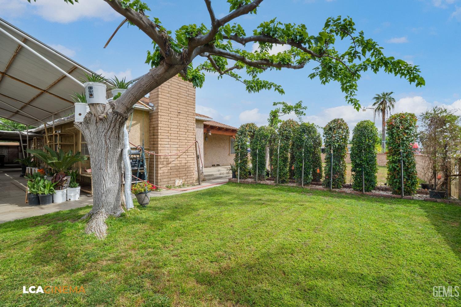 Undisclosed Address Bakersfield, CA 93307 - Photo 6 of 18 a backyard of a house with lots of green space