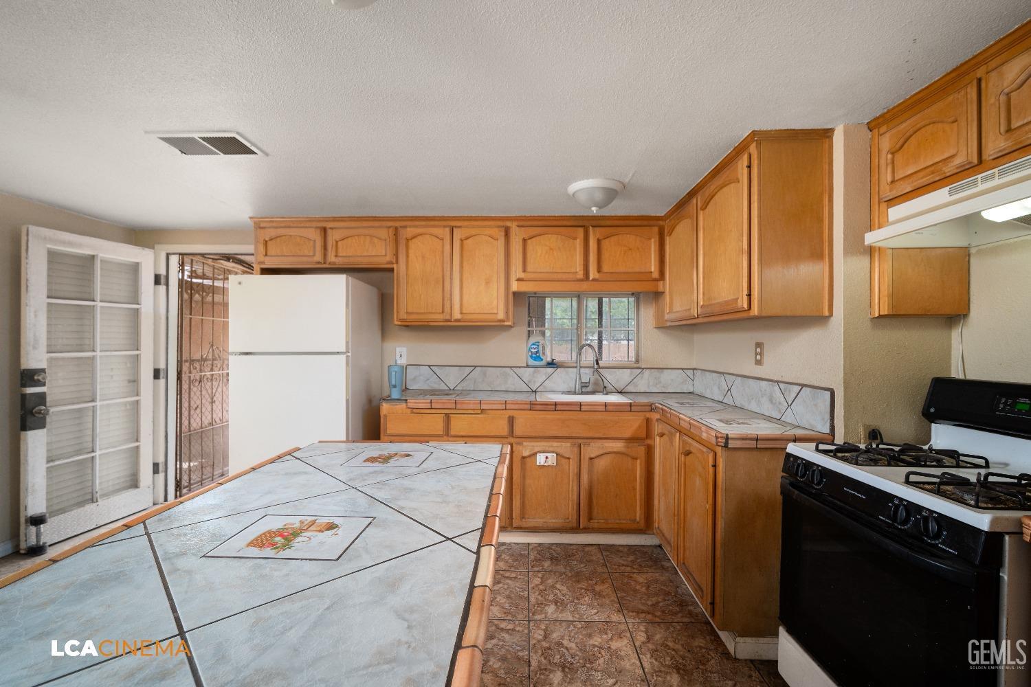 Undisclosed Address Bakersfield, CA 93307 - Photo 8 of 18 a kitchen with stainless steel appliances granite countertop a refrigerator sink and cabinets