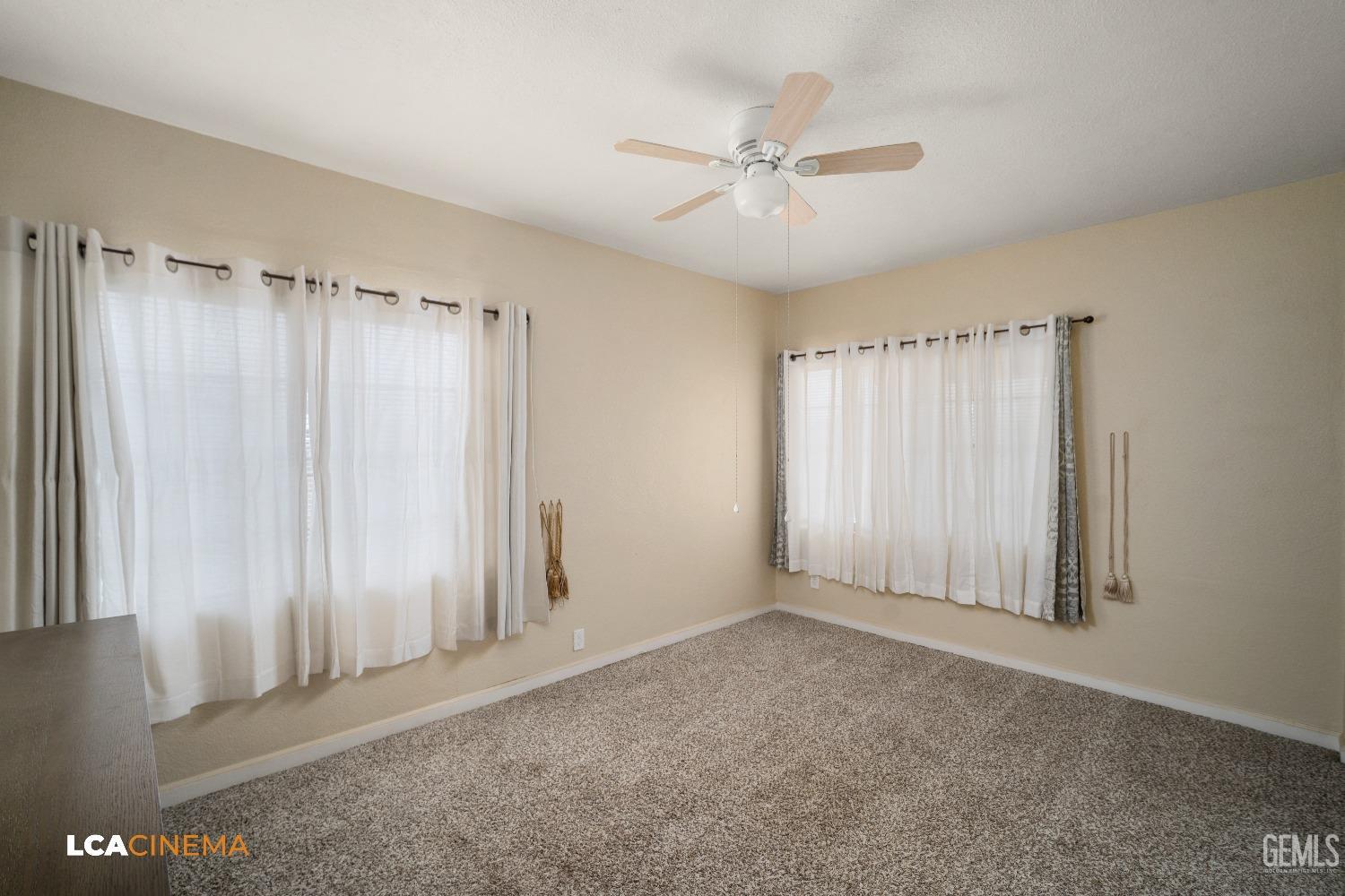 Undisclosed Address Bakersfield, CA 93307 - Photo 9 of 18 an empty room with windows and fan
