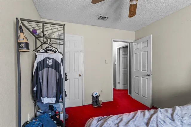 a bedroom with a bed and a mirror