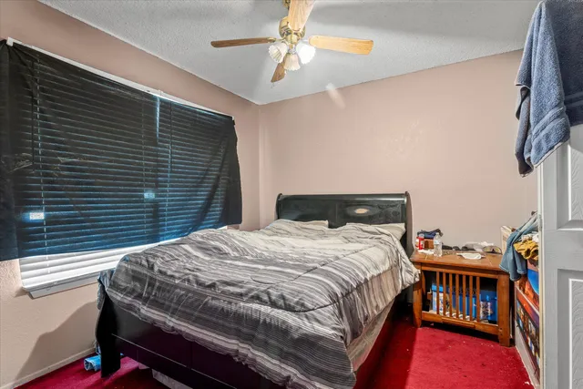 a bedroom with a bed and a book shelf