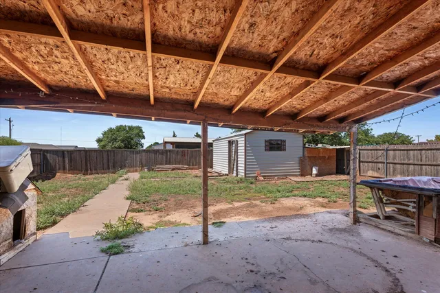 a view of a backyard with wooden fence