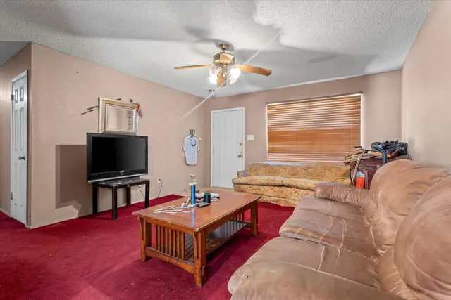 a spacious bedroom with a bed and a flat screen tv