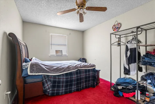 a bed sitting in a bedroom next to a window