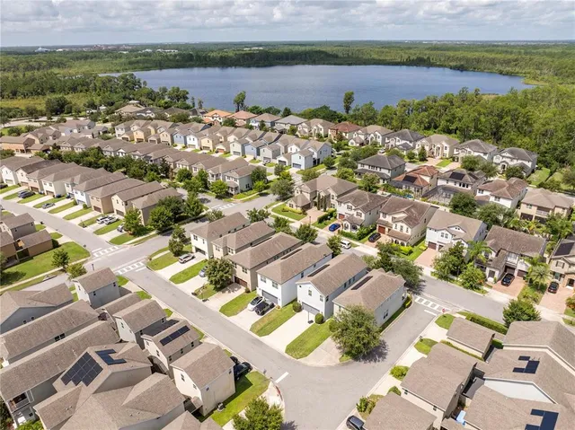 an aerial view of a house with yard swimming pool and outdoor seating