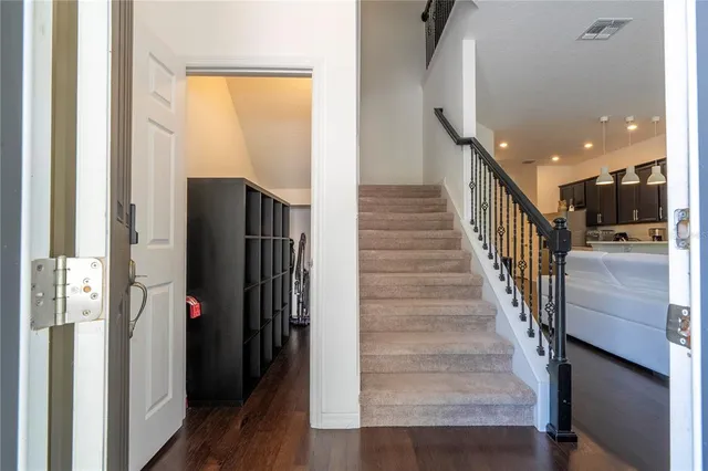 a kitchen with a refrigerator and a stove top oven