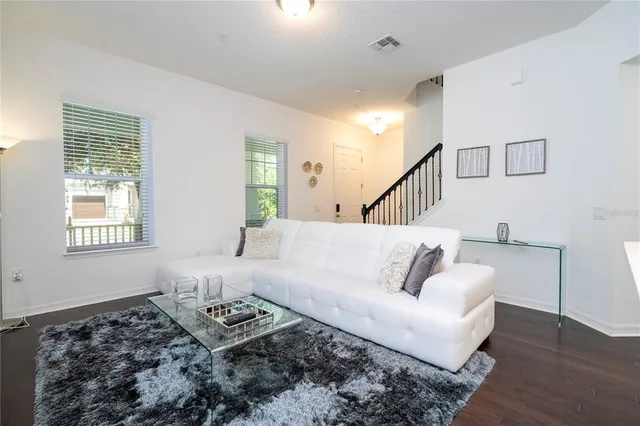 a view of a dining room with furniture a chandelier and wooden floor