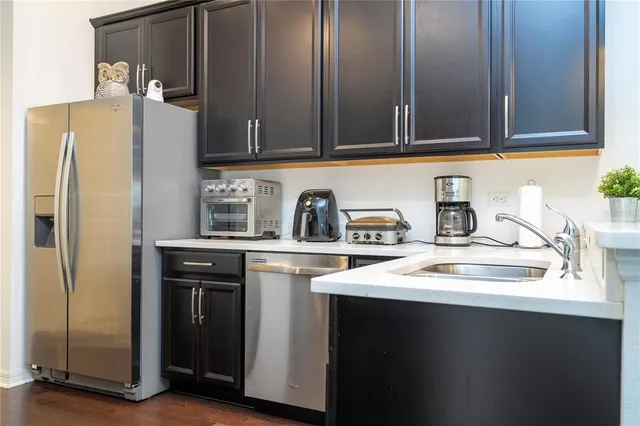 a bedroom with a bed and flat tv screen on the dresser