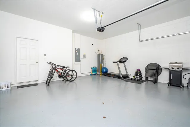 a bathroom with a granite countertop sink a large mirror and a light fixture