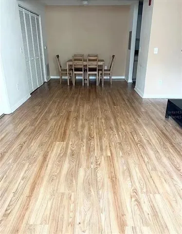 a dining room with furniture and wooden floor