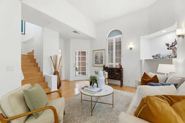 a view of a workspace with furniture and wooden floor