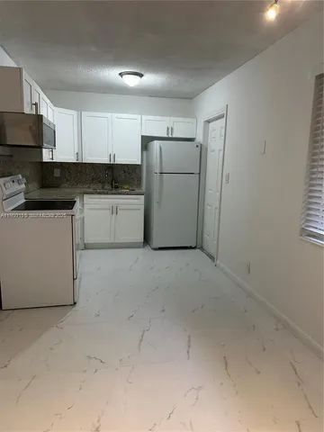 a bathroom with a sink a toilet and bathtub